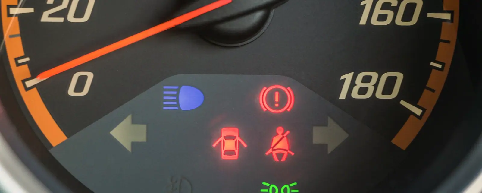 A car dashboard with an illuminated warning light